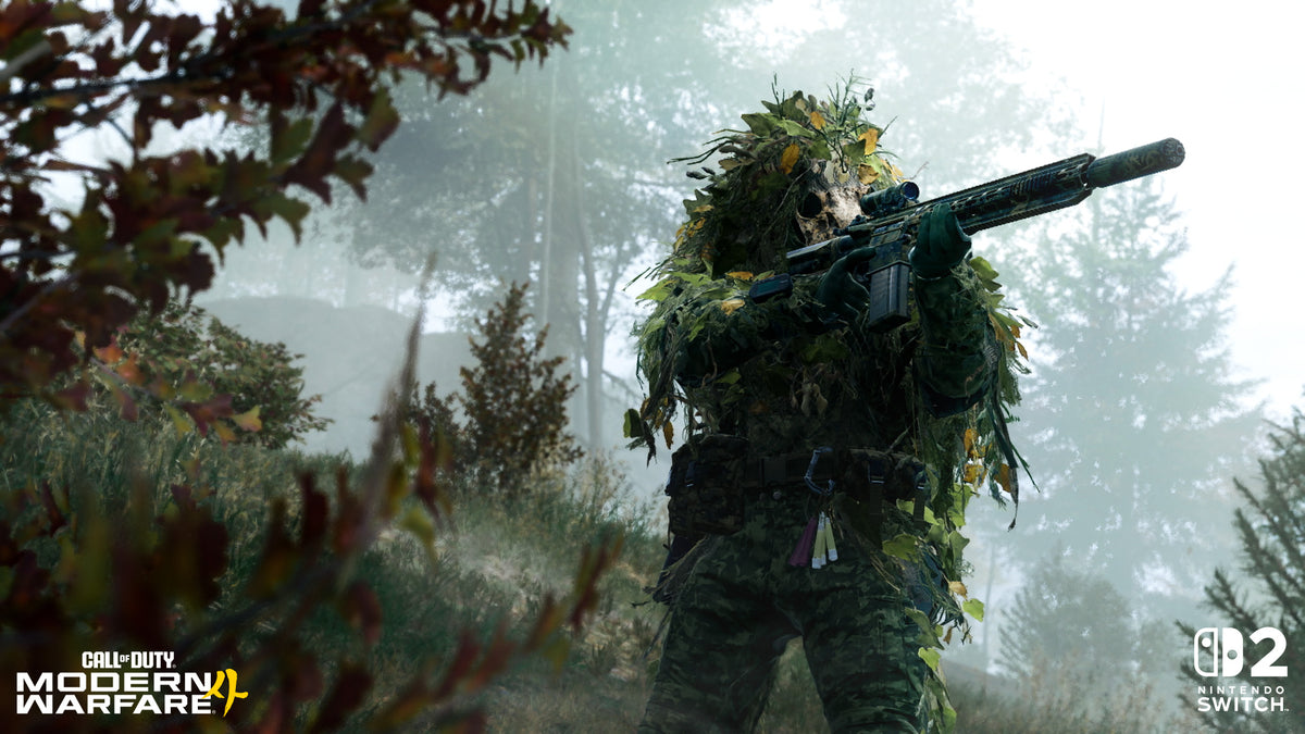 A figure in a ghillie suit with a skull over the face, aiming a suppressed rifle in misty woods