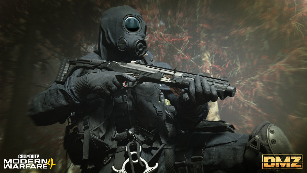 An Operator in a gas mask aims a pistol in the woods