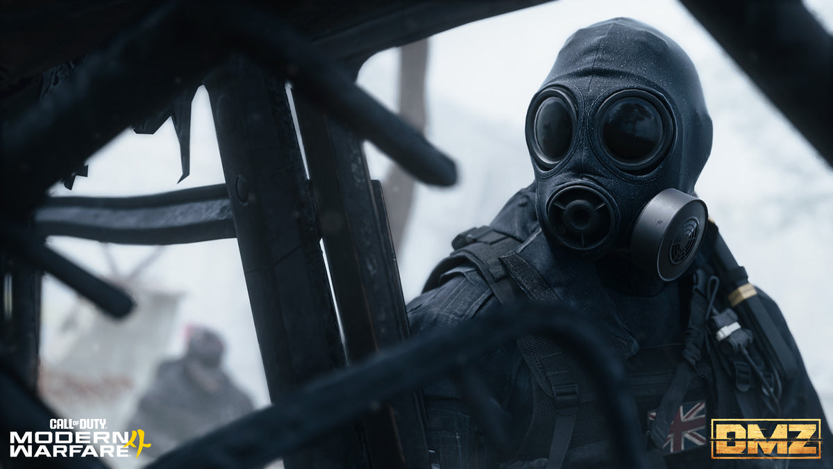 An Operator in a gas mask rides in a helicopter over Hajin