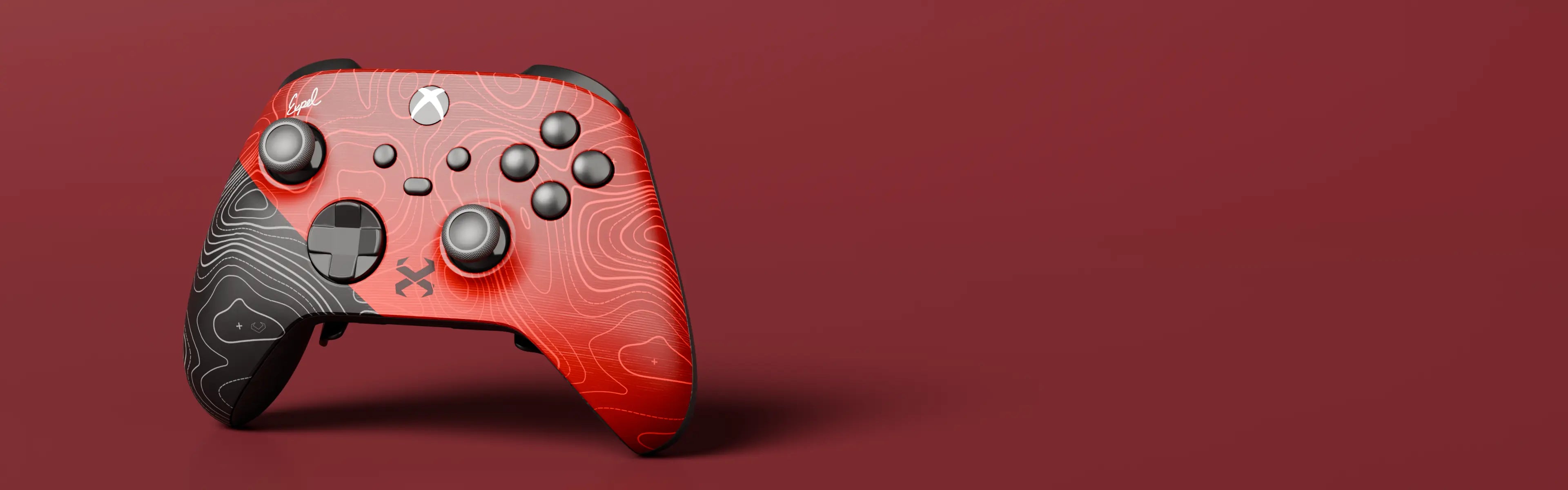 The Xbox-style Expel Pro+ on a seamless oxblood backdrop: red topographic front shell, matte black grips